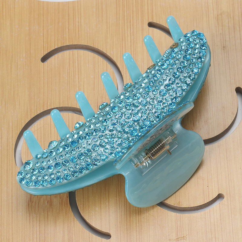Handmade rhinestone claw within Blue