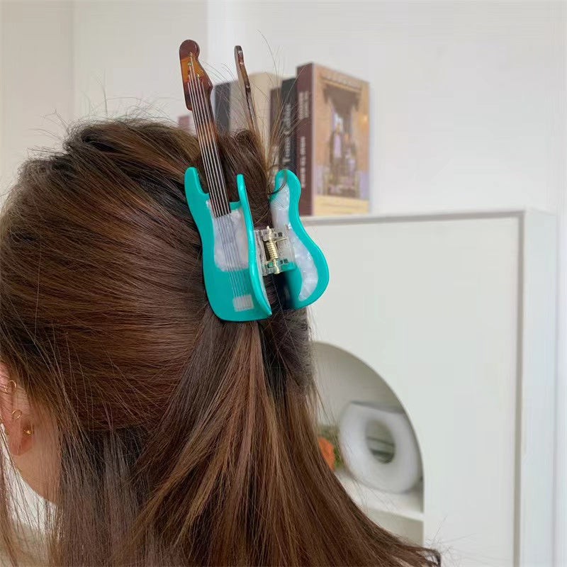 Mint green guitar hair claw