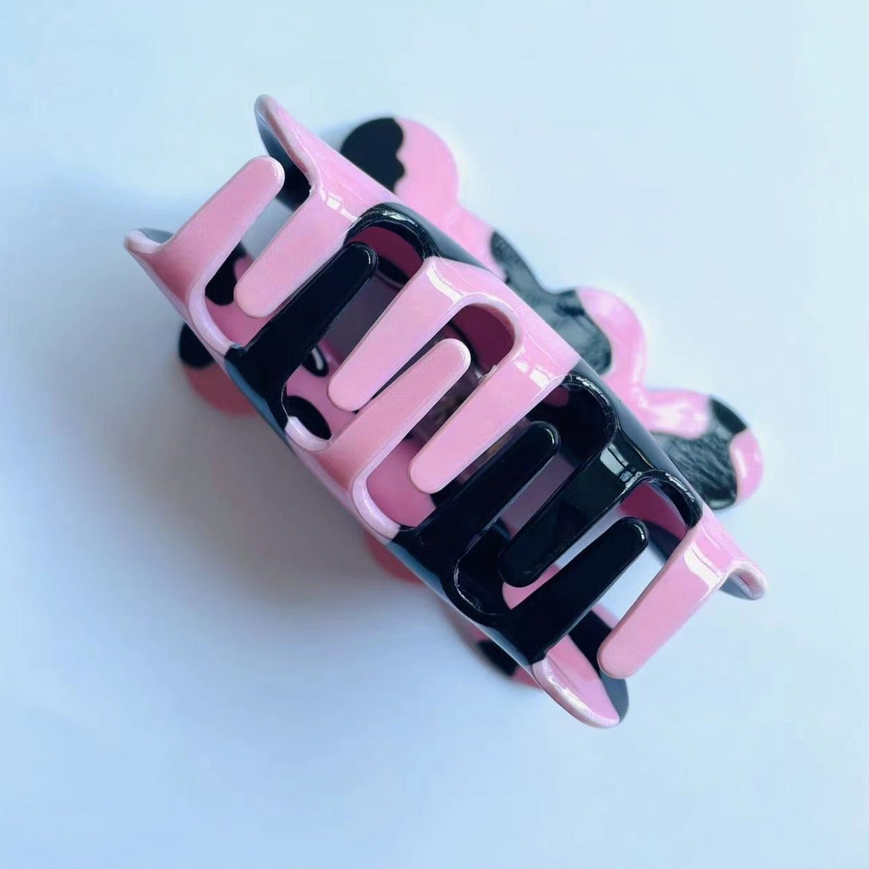 CURIOUS COW claw within pink