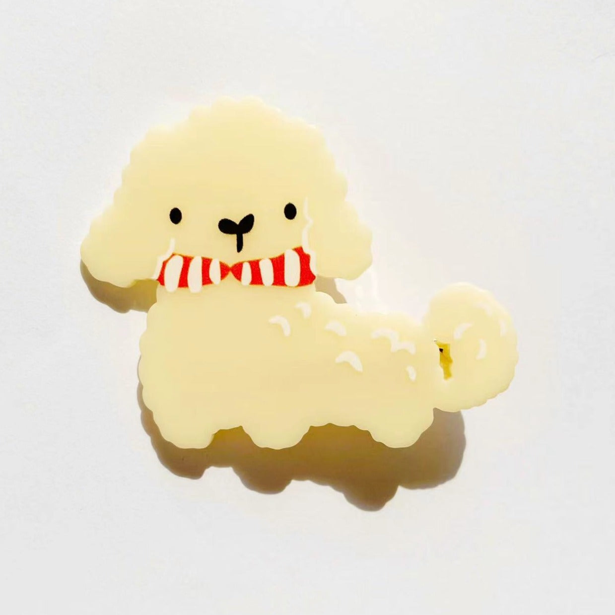 Cream dog with tie knot clip