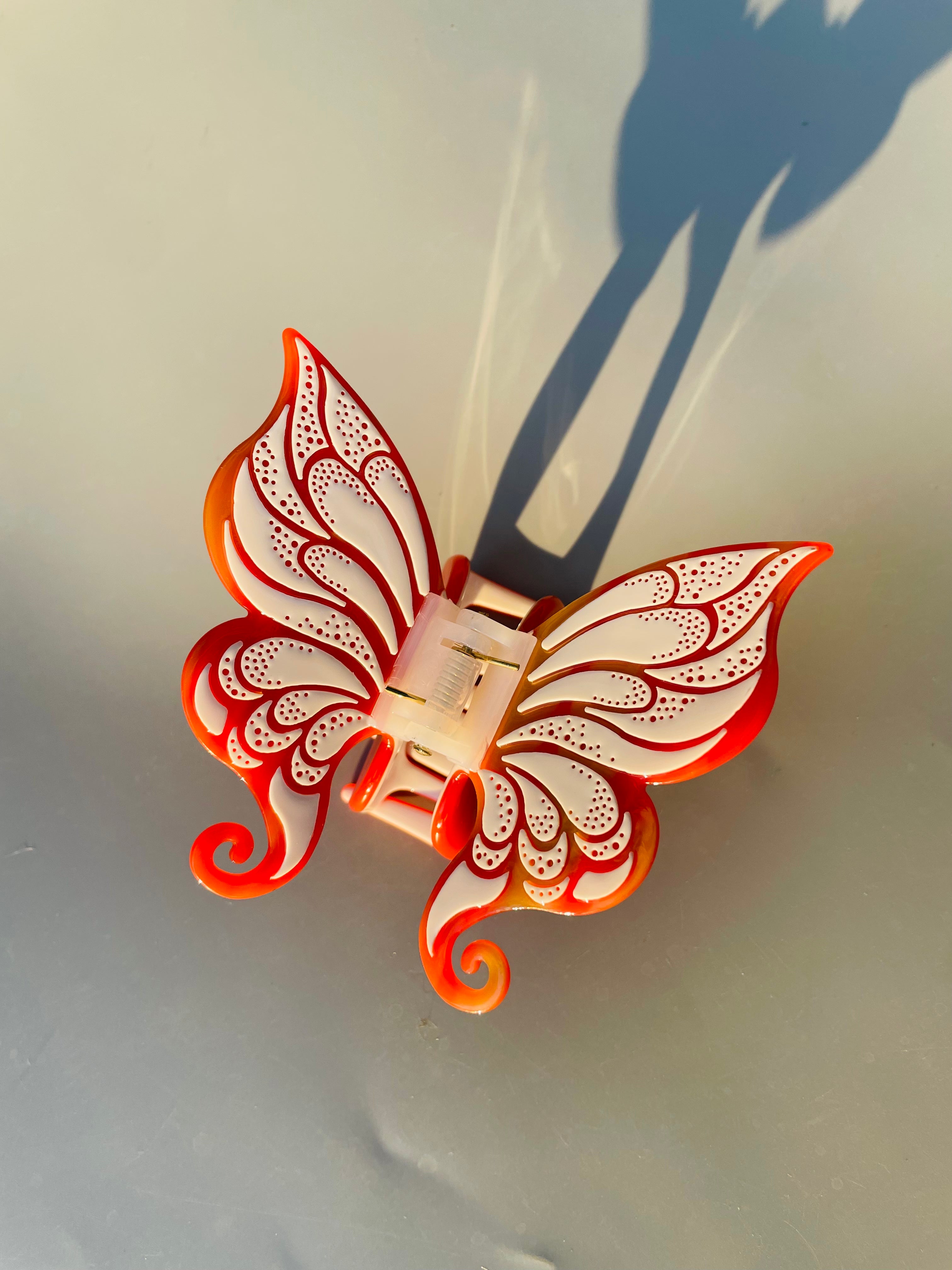 Handmade carved butterfly claw within Orange