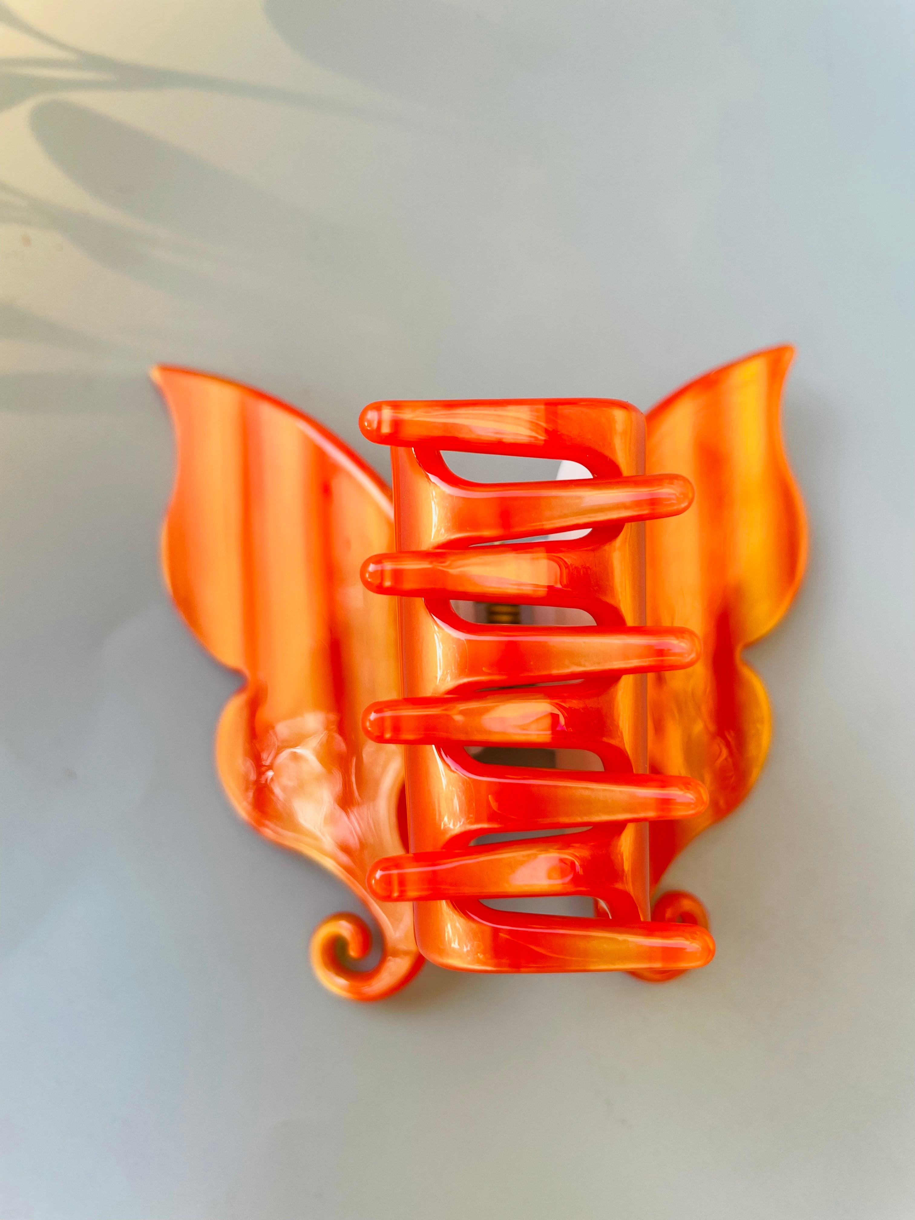 Handmade carved butterfly claw within Orange